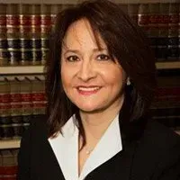 A woman wearing earrings is smiling for the camera