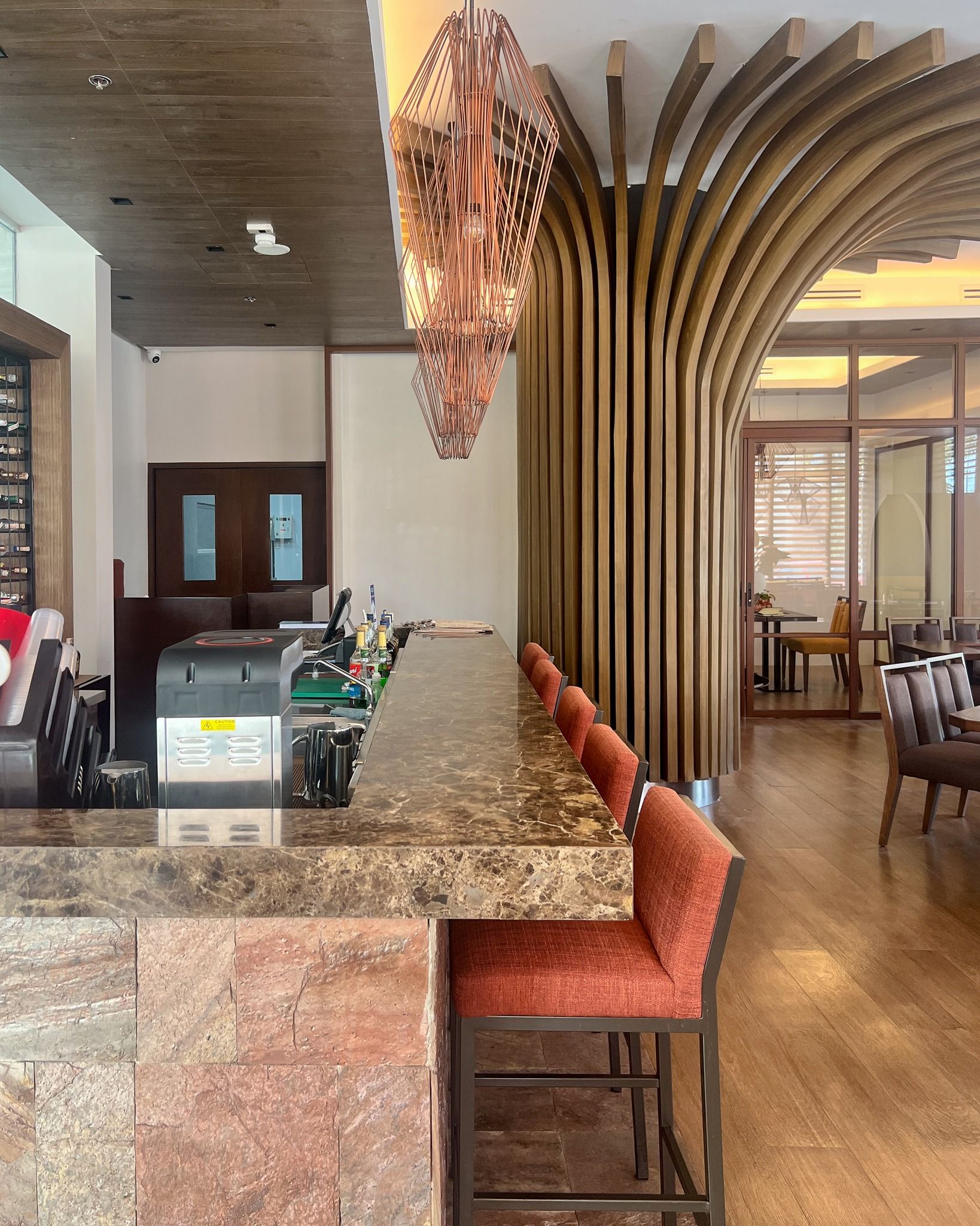 Elegant hotel bar with marble counter and wooden arch decor at Aurora Subic