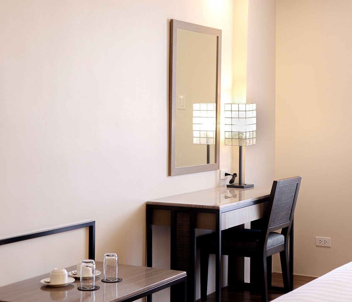 Modern hotel room desk with mirror and lamp at The Aurora Subic Hotel