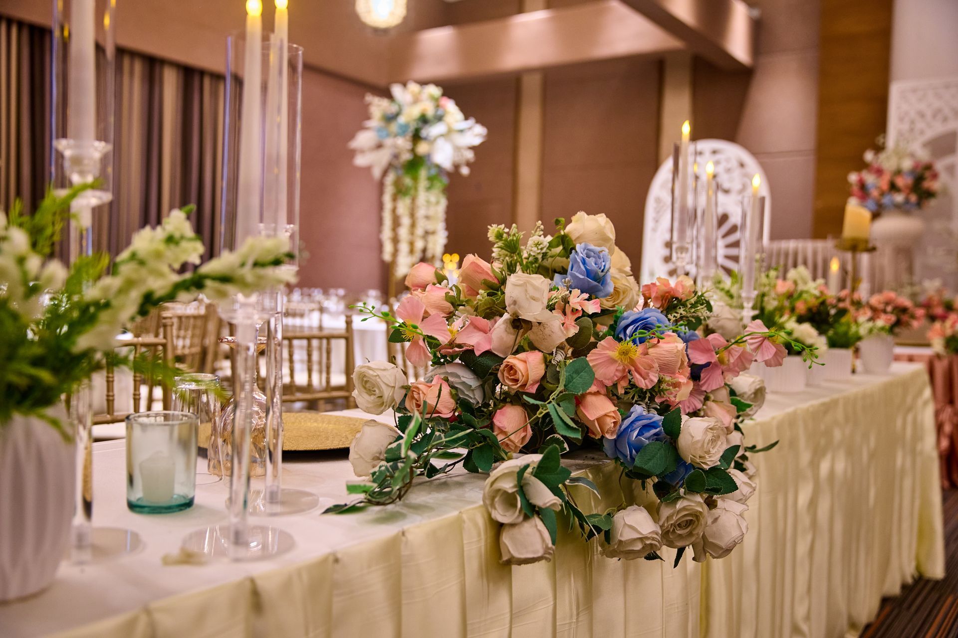 A long table with flowers and candles in an event room in subic