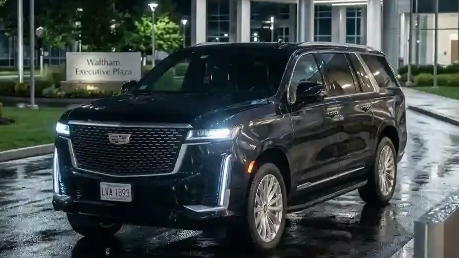 Black 2026 Cadillac Escalade executive SUV parked in Waltham for luxury chauffeur and black car transportation service.
