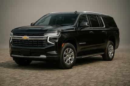 Black Chevrolet Tahoe SUV on a patterned floor.