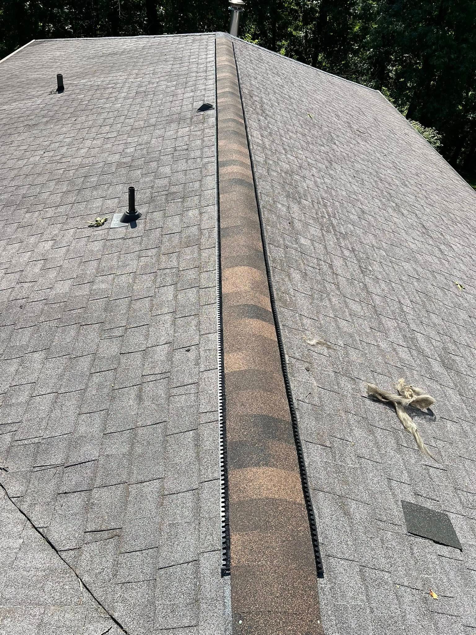 Roof with light gravel and a central brown ridge strip, seen from above
