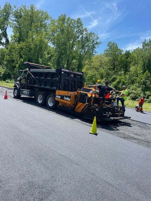 A dump truck is parked on the side of the road