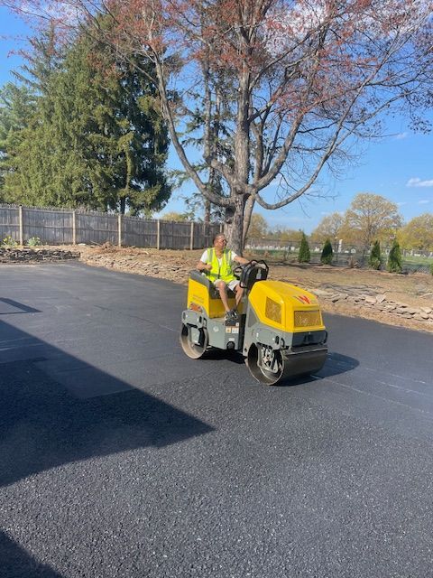 A man is riding a yellow roller on a road.