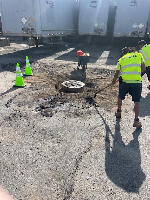 A group of construction workers are digging a hole in the ground.