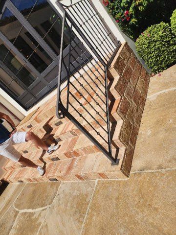A person is walking down a set of stairs with a railing.