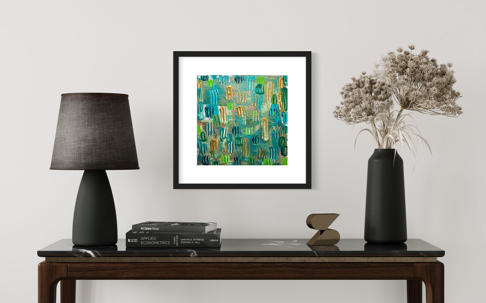A framed painting is hanging on a wall above a table.