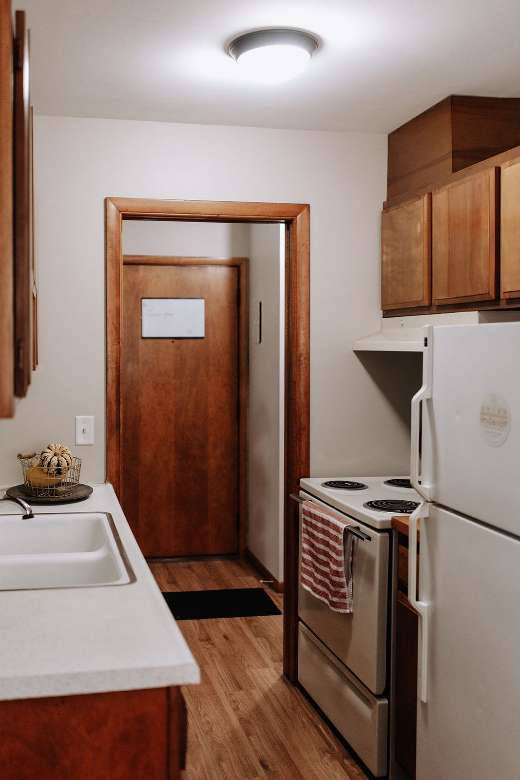 Kitchen with warm wood and fall decor. A basket of pumpkins sits on the counter.
South Minneapolis apartments by RightMove Properties.
