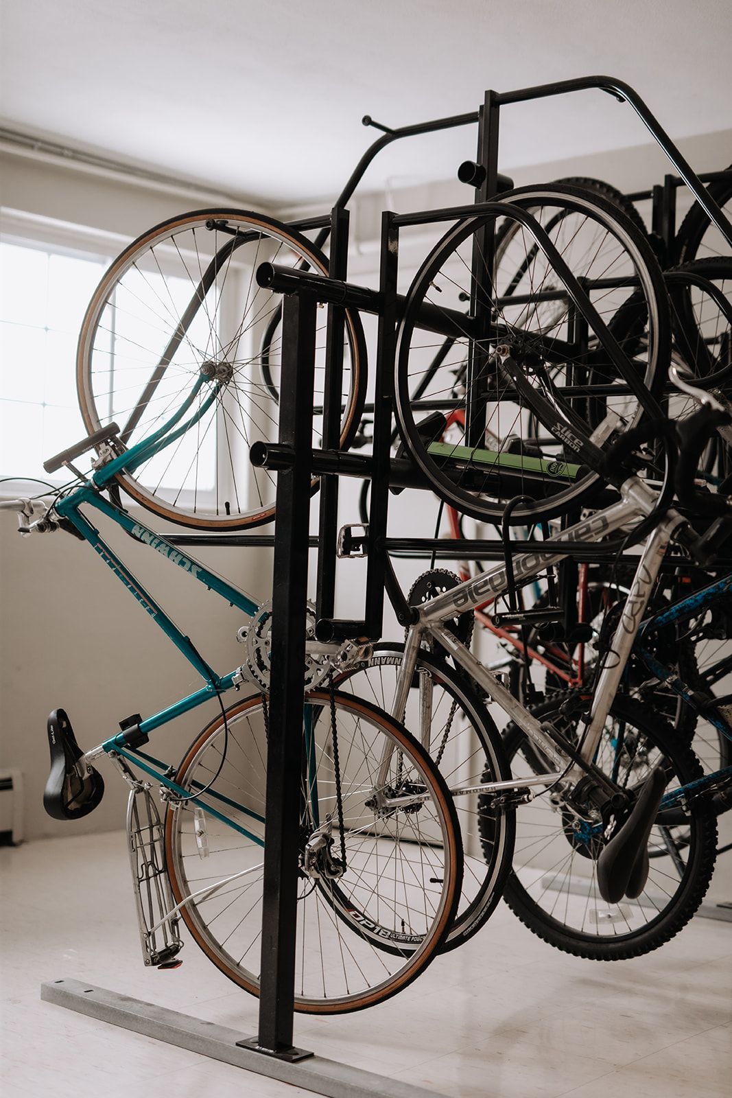 Several bikes vertically on a bike rack. South Minneapolis apartments by RightMove Properties.