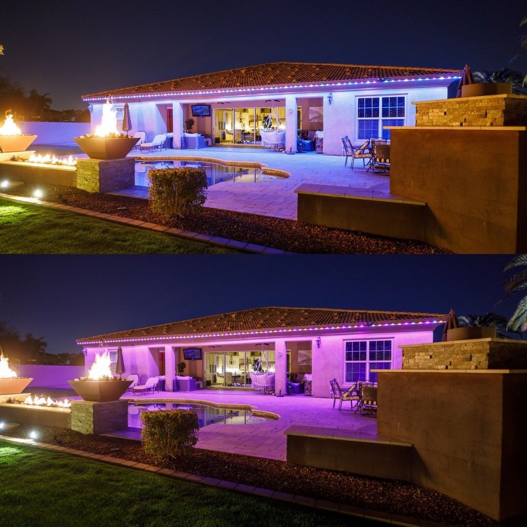 House exterior at night with changing purple-blue accent lights and a lit patio