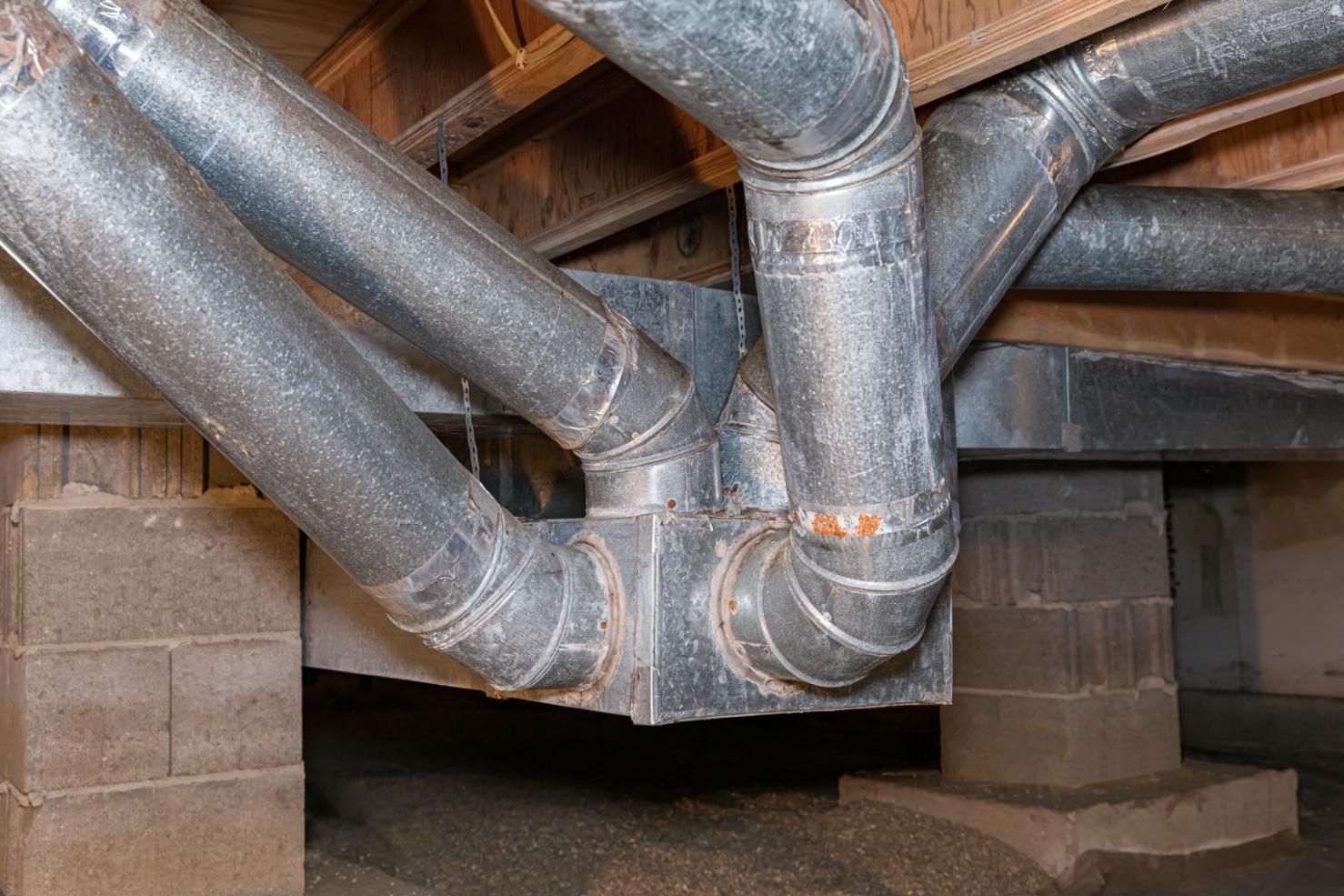 A bunch of pipes are connected to each other in a basement.