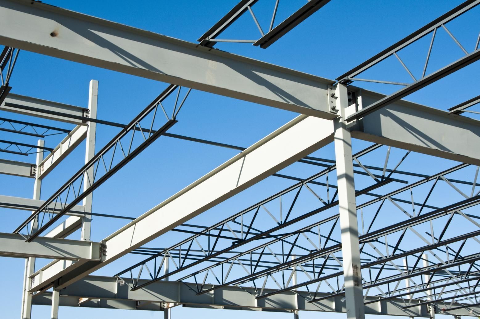 A building under construction with a blue sky in the background.