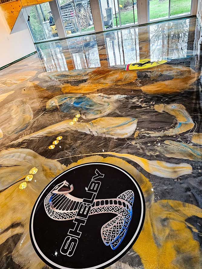 Sol en époxy avec motifs dorés en forme de serpent. Tapis orné du logo Shelby.