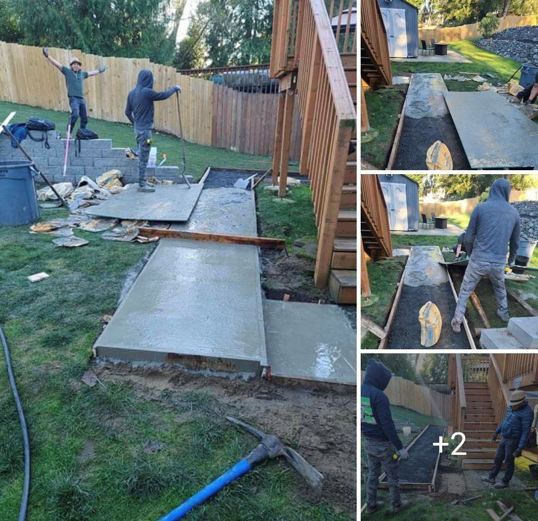 Concrete walkway being built in a backyard next to wooden stairs. People working, raising arms.