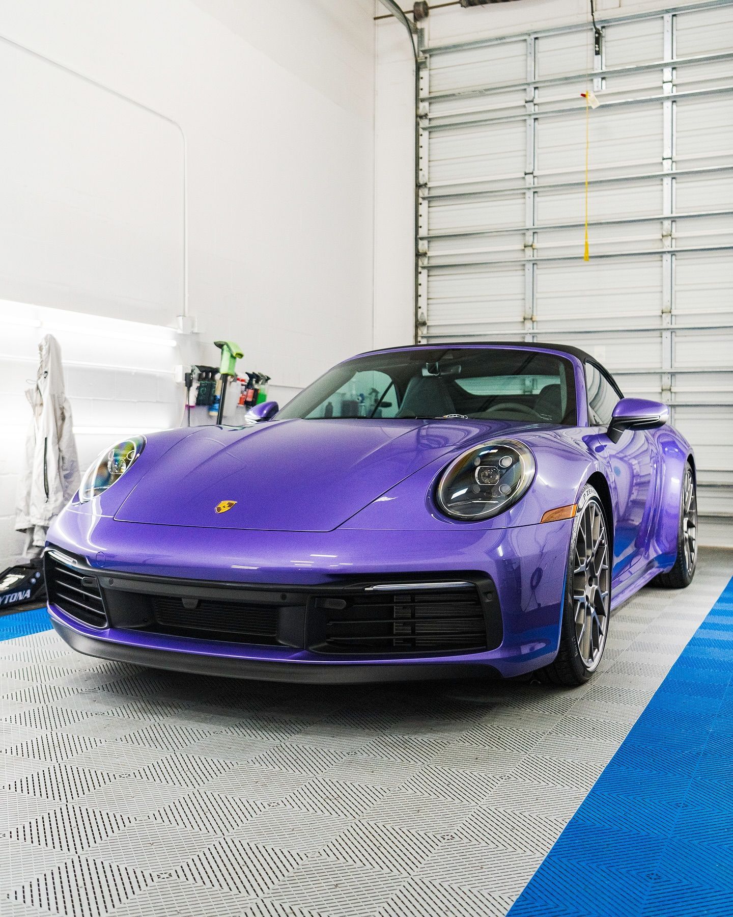 Purple Porsche with ceramic coating in a professional auto detailing shop.