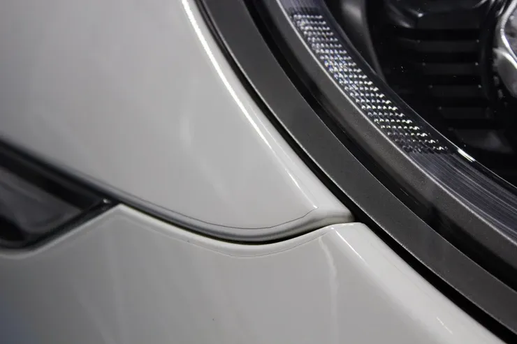 A close up of a white car 's headlight.