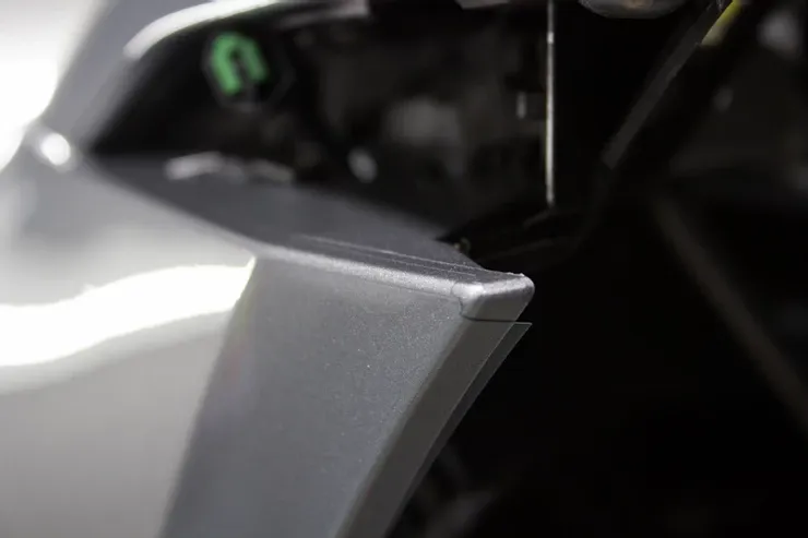 A close up of a car wheel with a green sticker on it.