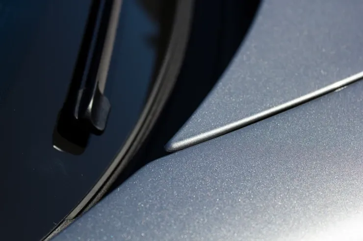 A close up of a car windshield with a wiper on it.