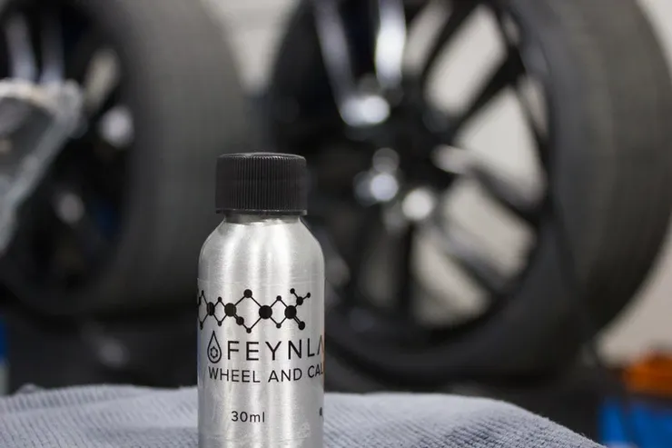 A silver bottle of feynl wheel and car polish