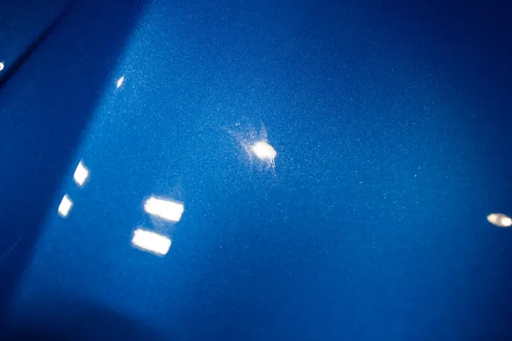 A close up of a blue surface with white spots on it.