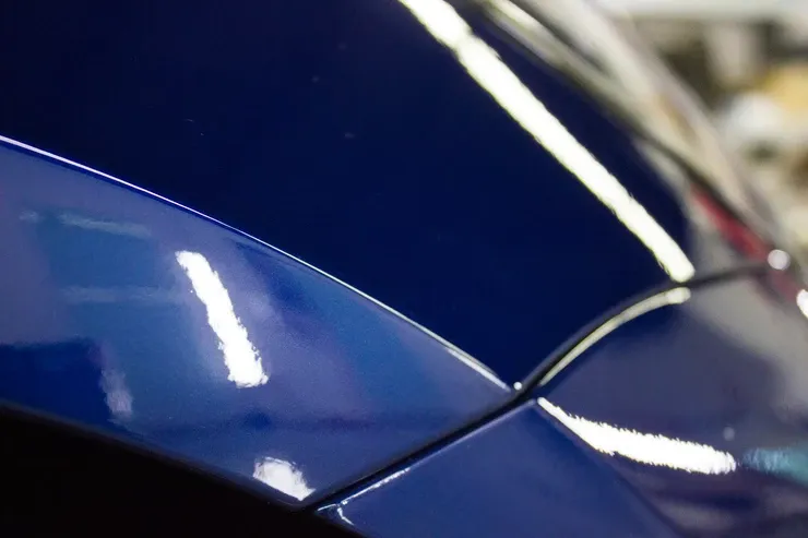 A close up of the side of a blue car