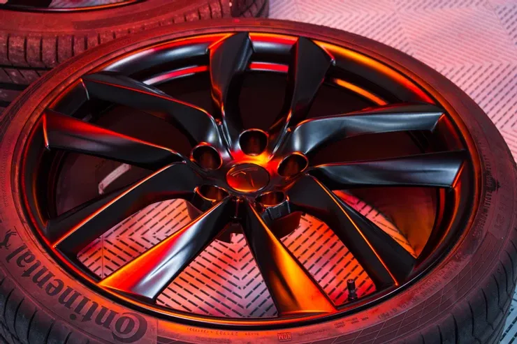 A close up of a continental tire on a car wheel