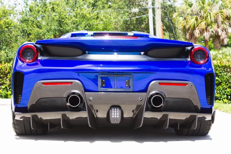 The rear end of a blue sports car is shown.