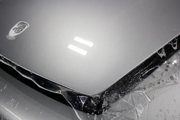A close up of a laptop with water coming out of it.