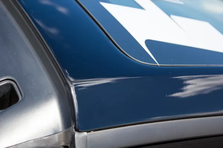 A close up of a blue car with a white arrow on it