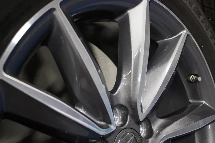 A close up of a car wheel with a tire on it.