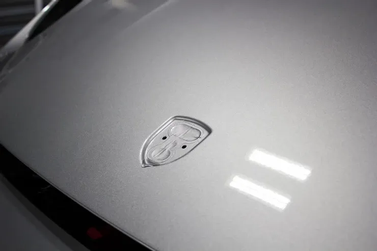 A close up of the hood of a white car.