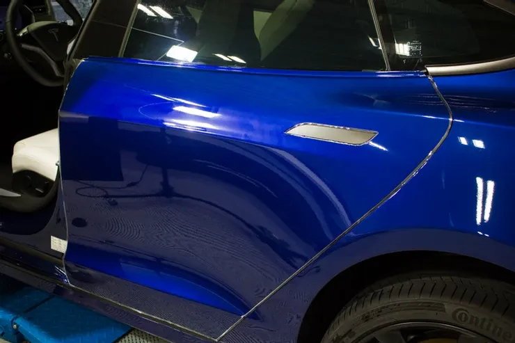 A close up of a blue car with the door open