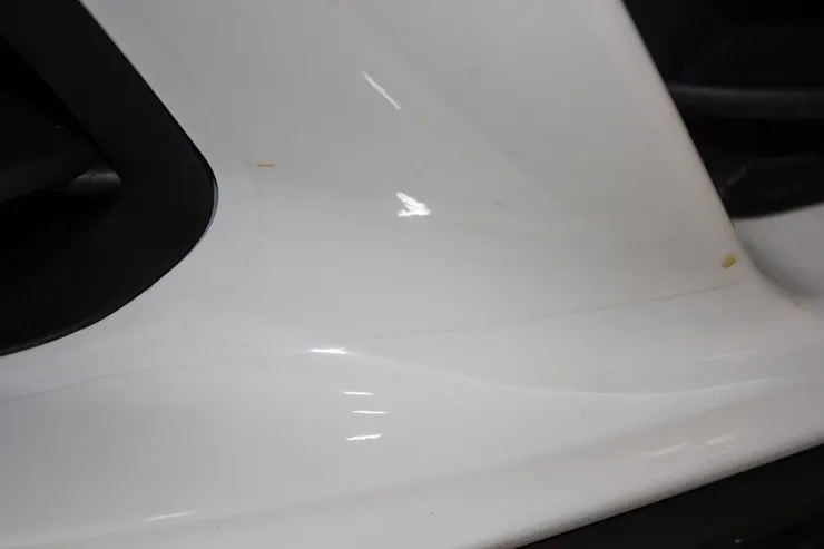 A close up of a white car wheel with a black rim.