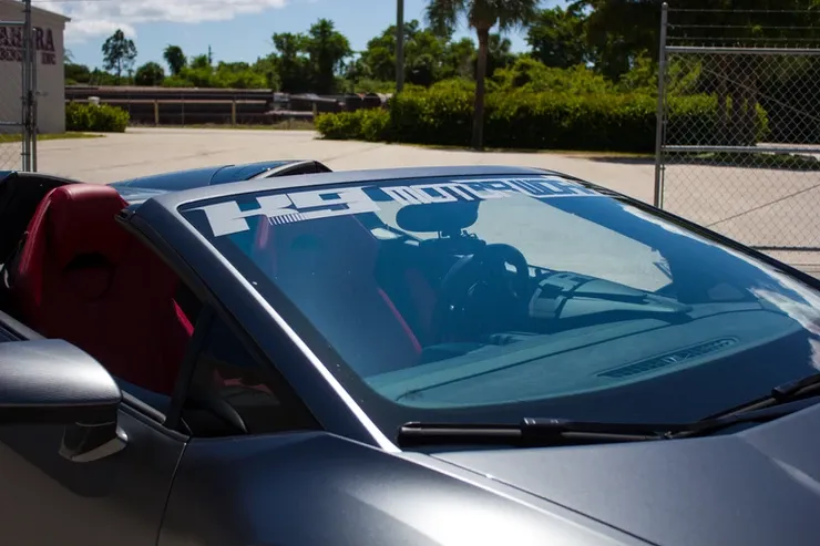 A convertible sports car with a h9 sticker on the windshield