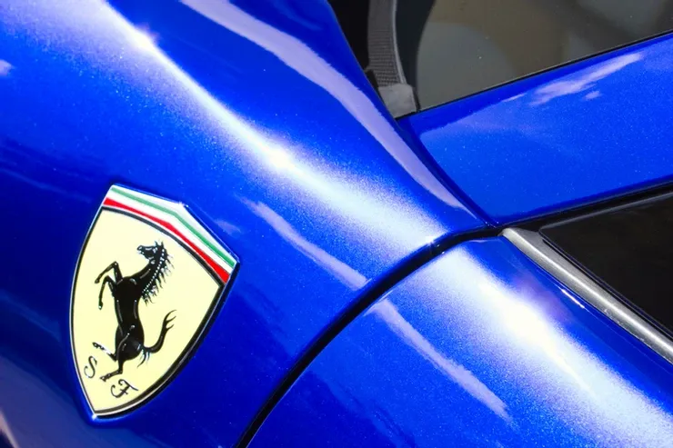 A blue car with a ferrari logo on the side