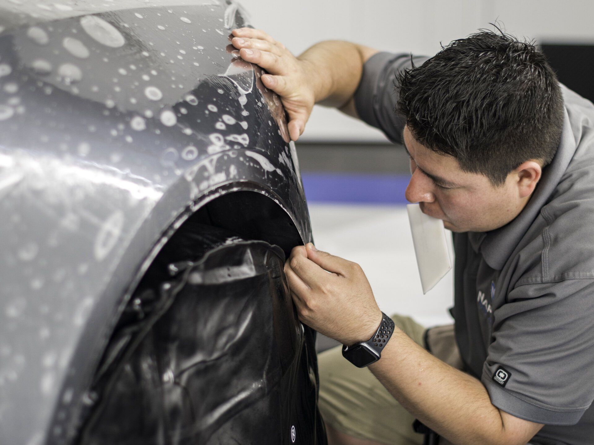 a ppf installer installing ppf on a car