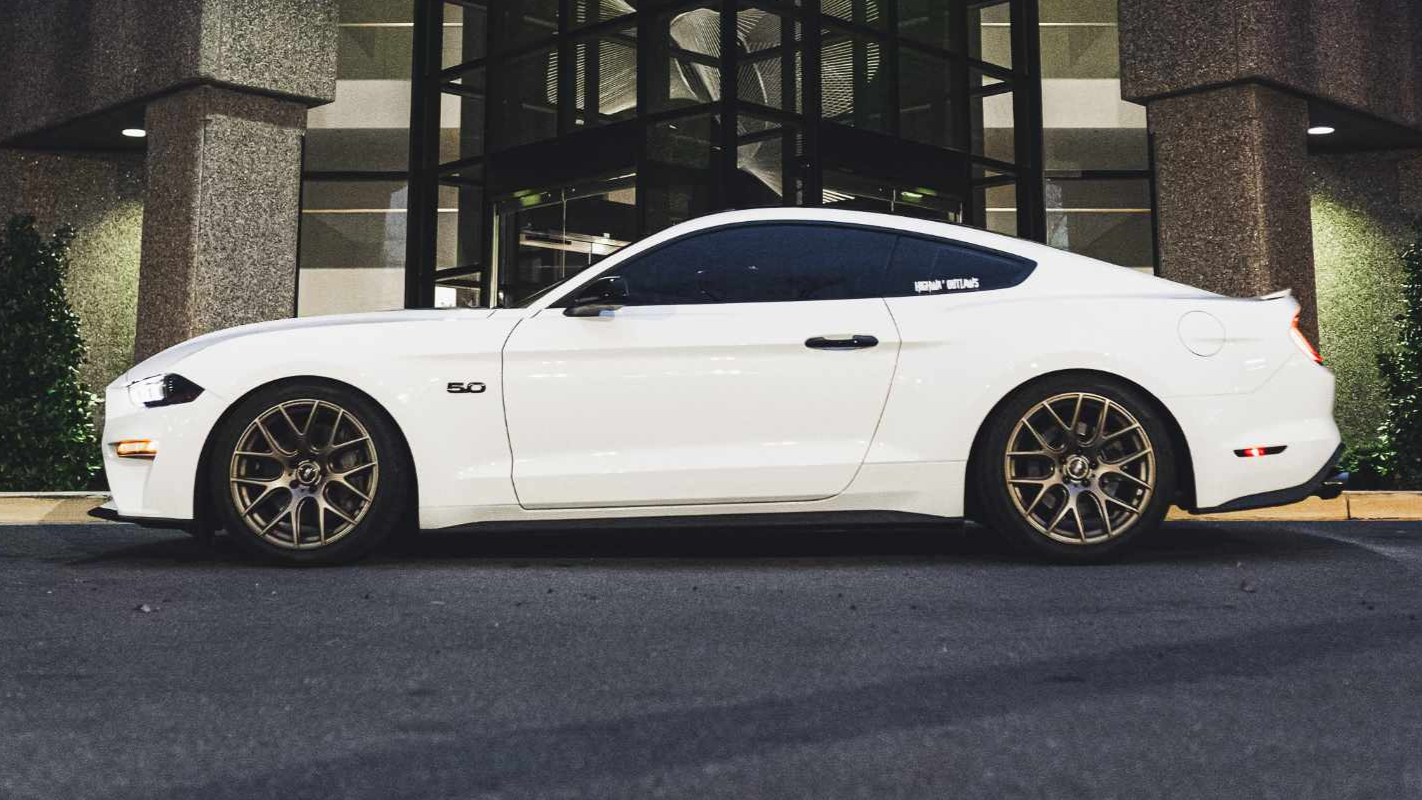 White Ford Mustang with professional window tinting.