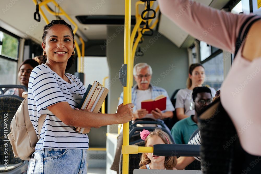 A smiling woman in a public bus.