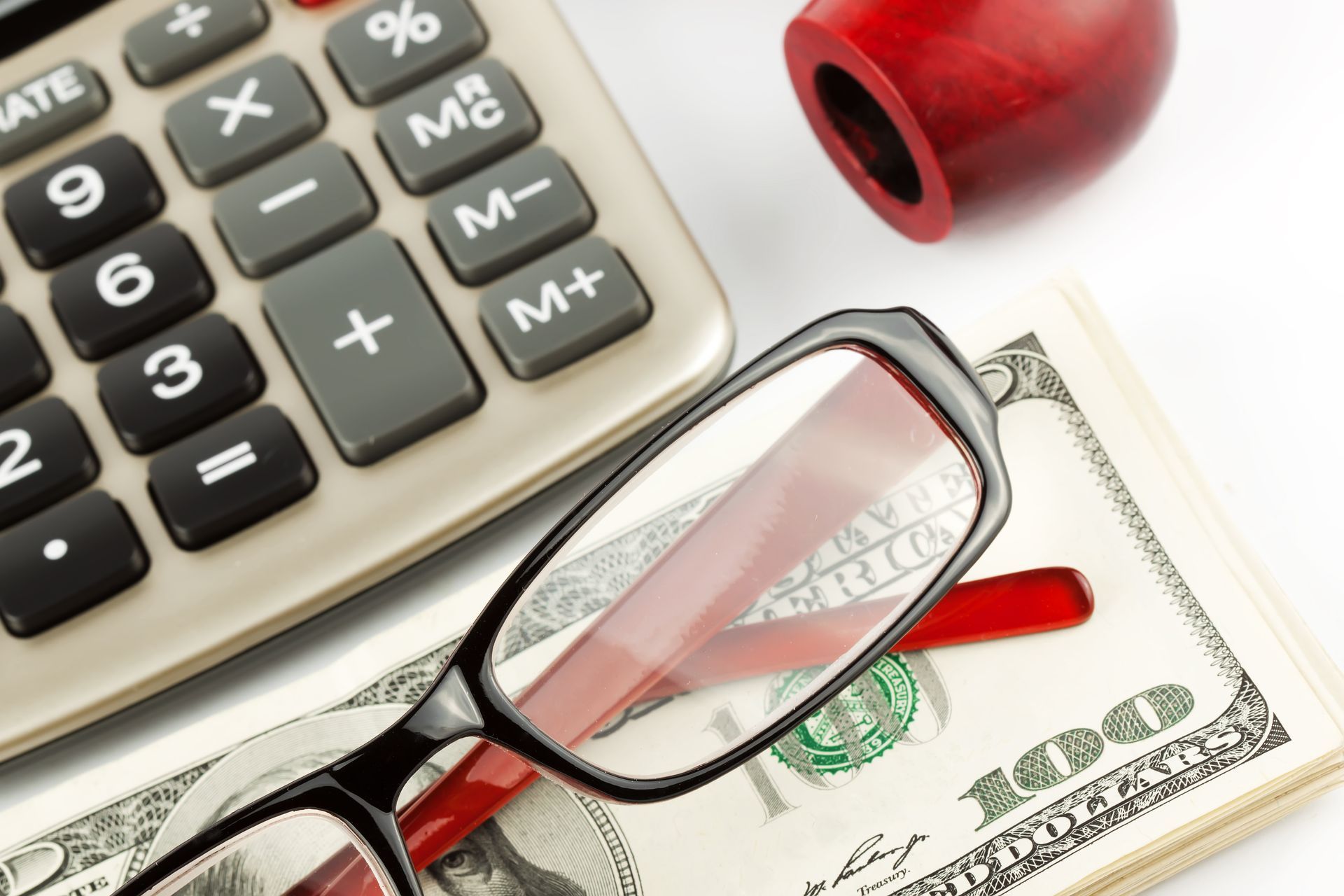 financial literacy closeup pen calculator cash glasses