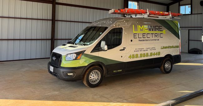 White and green service van with roof equipment parked inside a garage warehouse