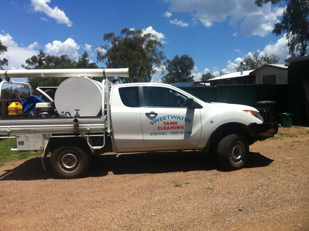White pickup truck with a water tank and