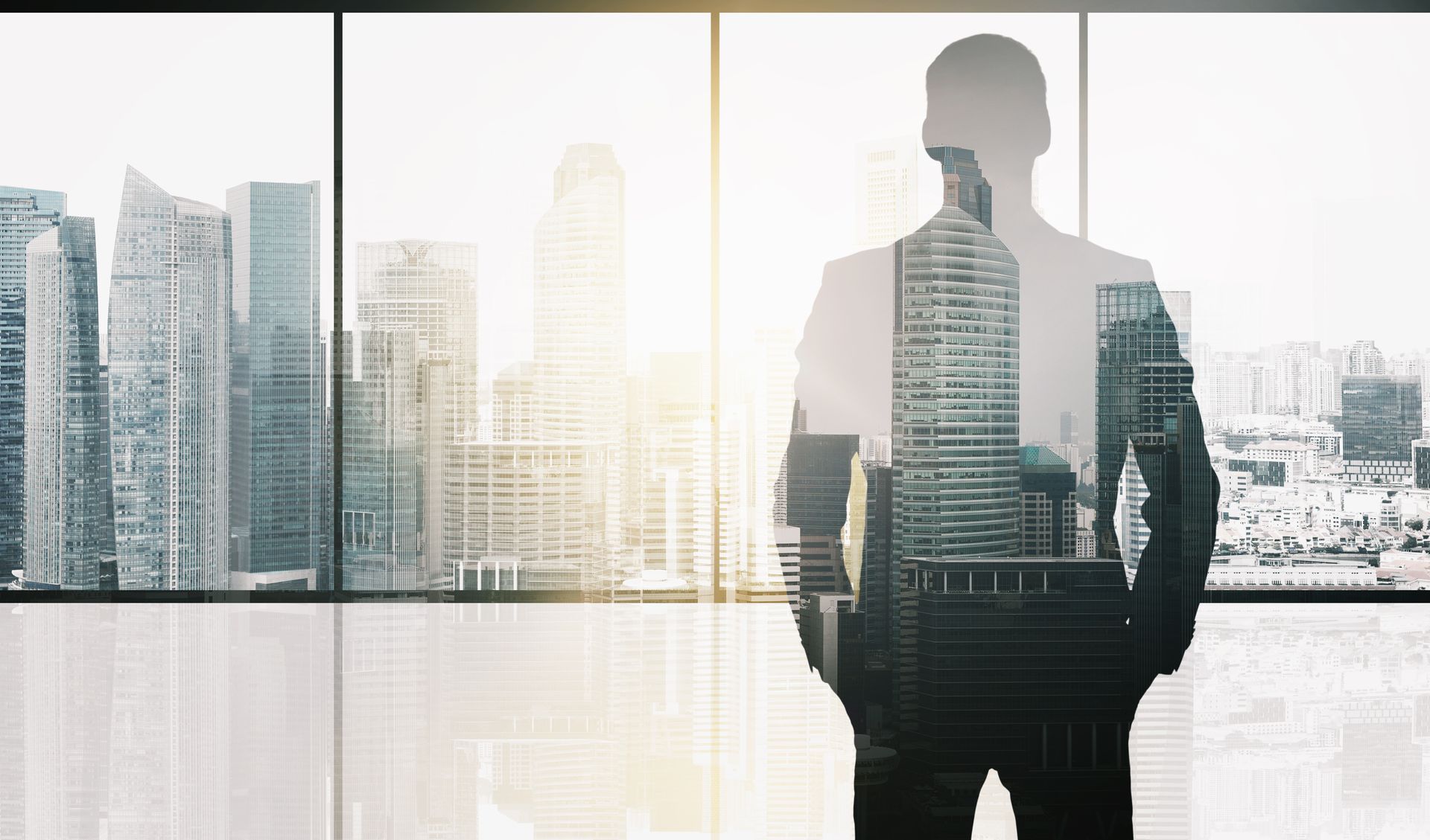 Silhouette of a person in a suit, overlaid on a cityscape viewed through a large window.