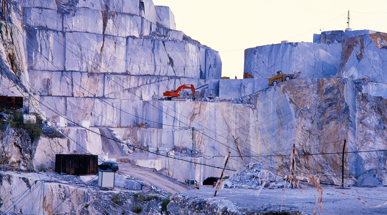 A large block of marble is being cut in a quarry.