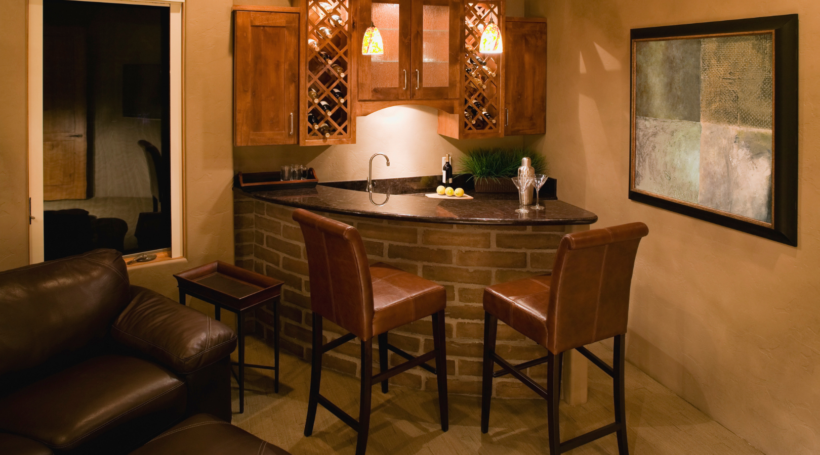 A living room with a couch , chairs , and a bar.