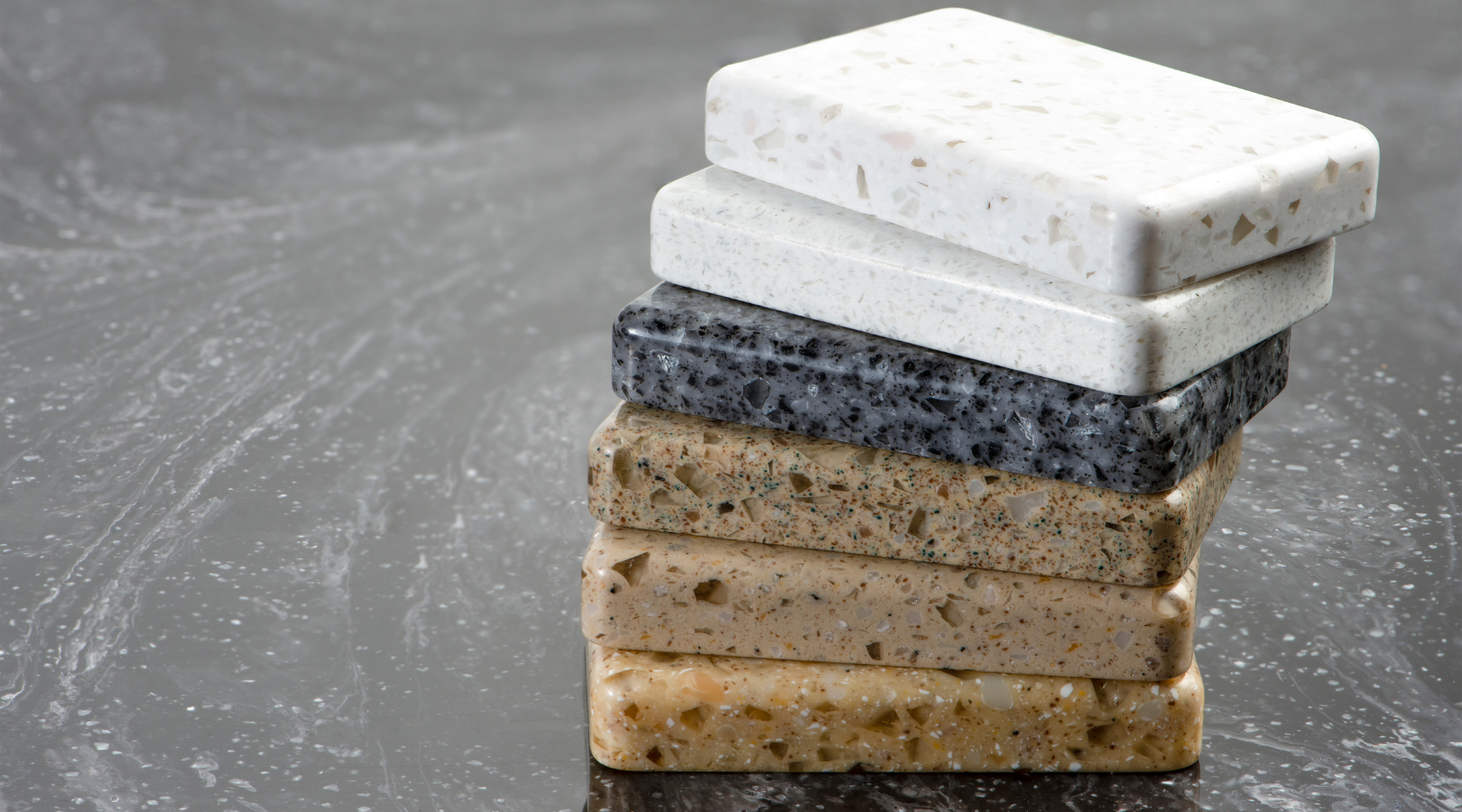 A stack of different types of granite slabs on a table.