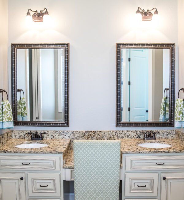 A bathroom with two sinks and two mirrors