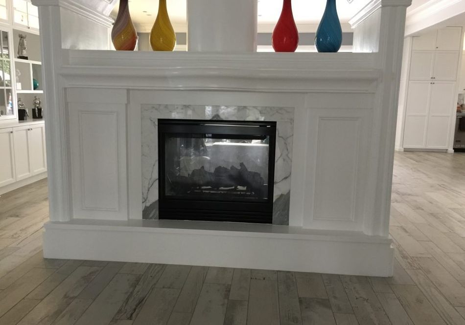 There is a fireplace in the middle of the room.