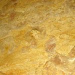 A close up of a yellow marble texture.