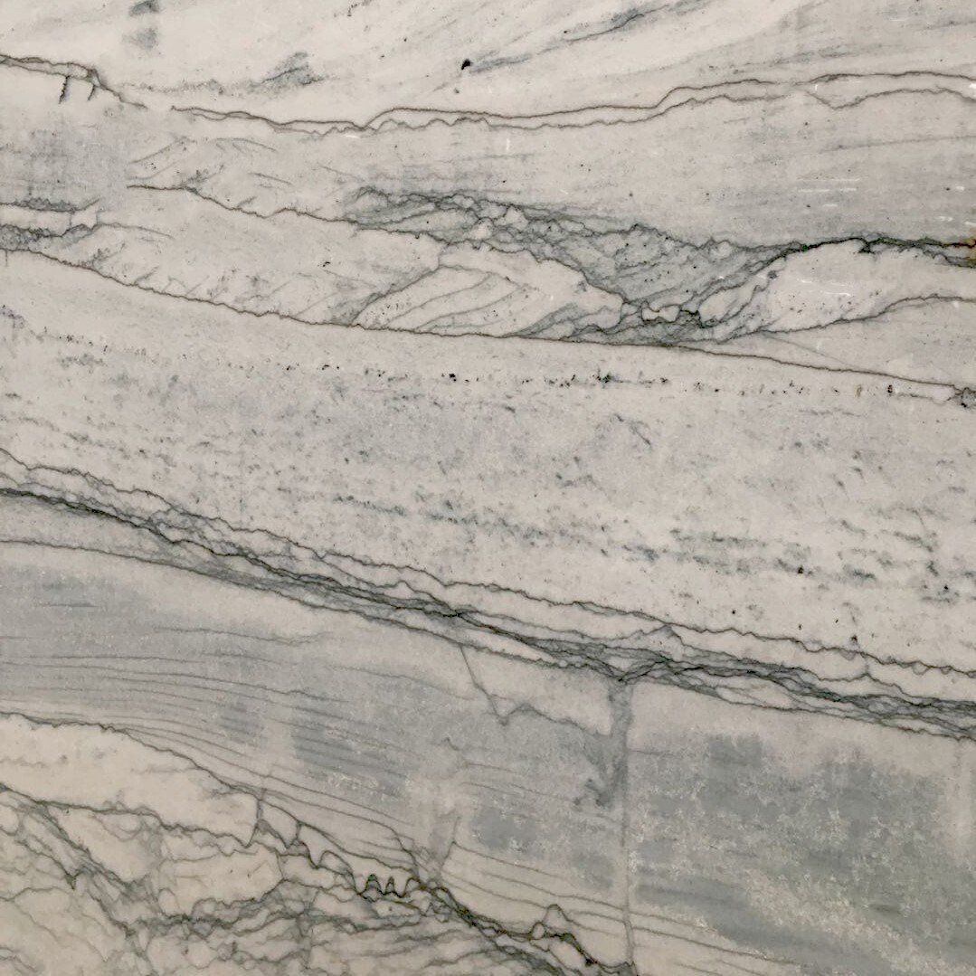 A close up of a white marble counter top